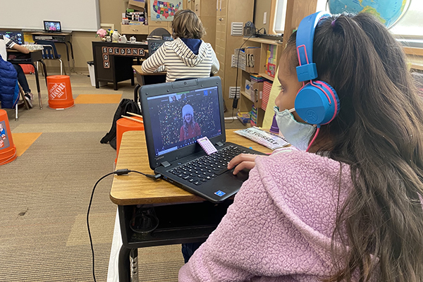 Student watching performance on computer